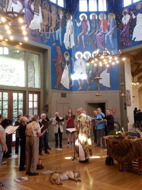 The Choir practicing the Hymn to John Muir before the service, with the John Muir dancing saint icon middle top above Mahatma Gandhi in the church rotunda at St. Gregory of Nyssa Episcopal Church.